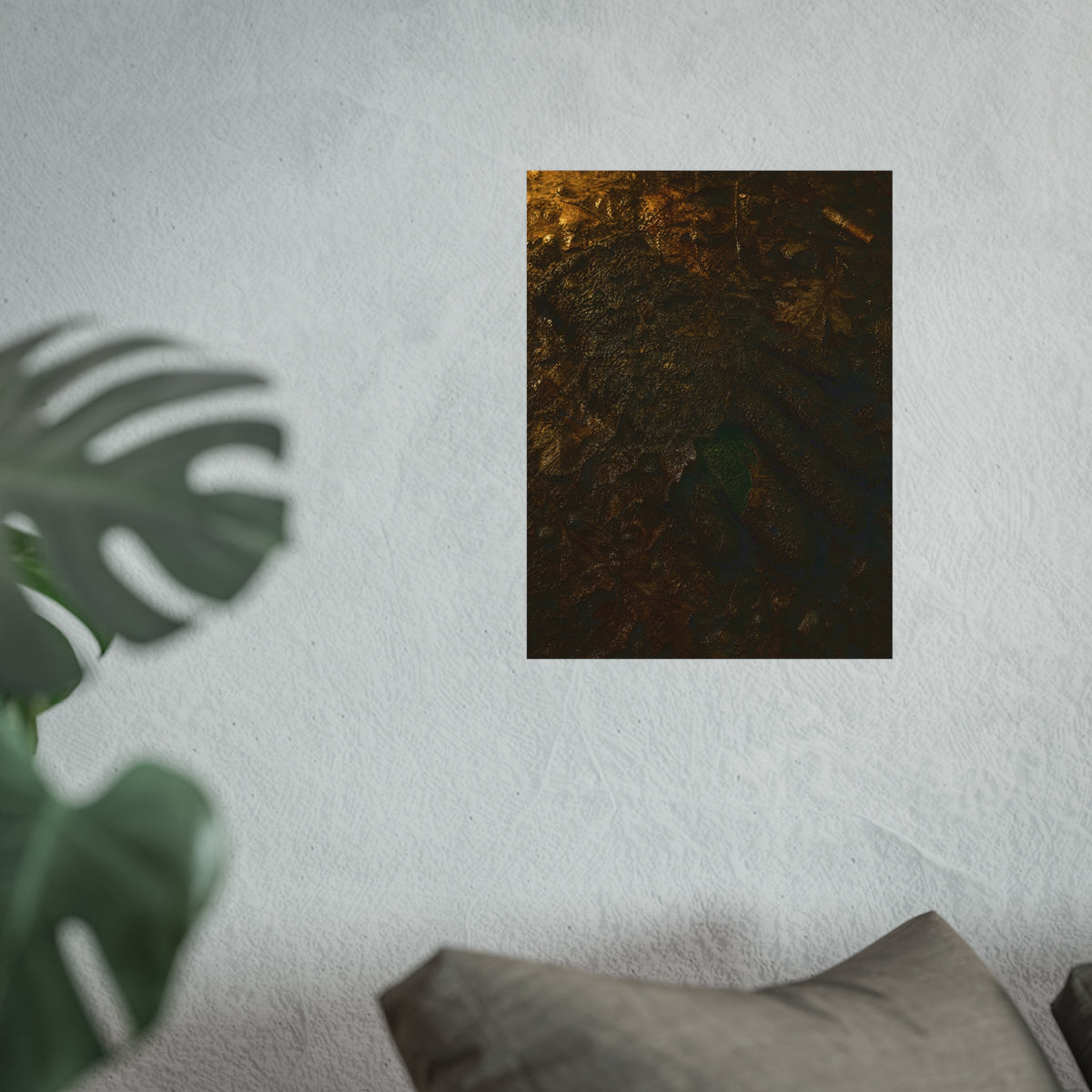 Wet mud and pressed oak leaves with a green scrap barely showing. The Reliquary of Mud and Leaf by Garabaggio, fine art print hanging in a room.