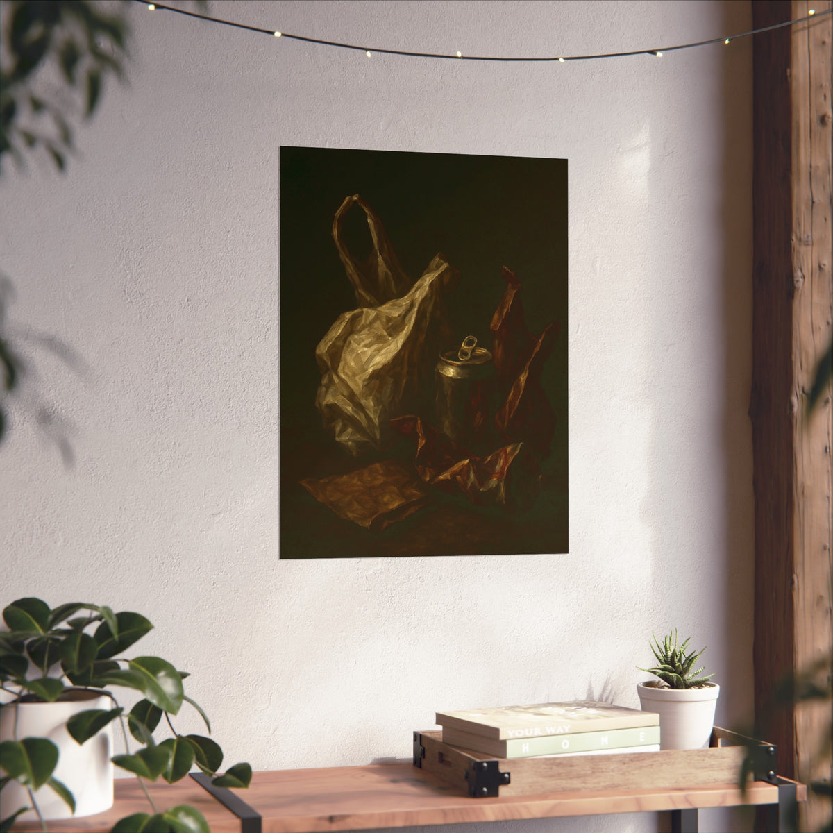 A crumpled plastic bag, crushed can and foil wrappers on a dark table. The Pietà of the Deflated by Garabaggio, fine art print hanging in a room.